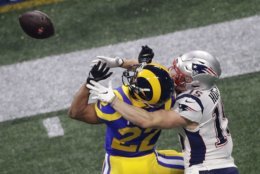 Los Angeles Rams' Marcus Peters (22) breaks up a pass intended for New England Patriots' Chris Hogan (15) during the second half of the NFL Super Bowl 53 football game Sunday, Feb. 3, 2019, in Atlanta. (AP Photo/Charlie Riedel)