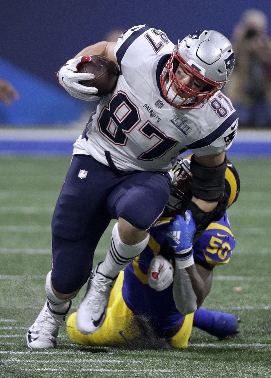 New England Patriots' Rob Gronkowski (87) is tackled by Los Angeles Rams' Samson Ebukam (50) after catching a pass during the second half of the NFL Super Bowl 53 football game Sunday, Feb. 3, 2019, in Atlanta. (AP Photo/David J. Phillip)