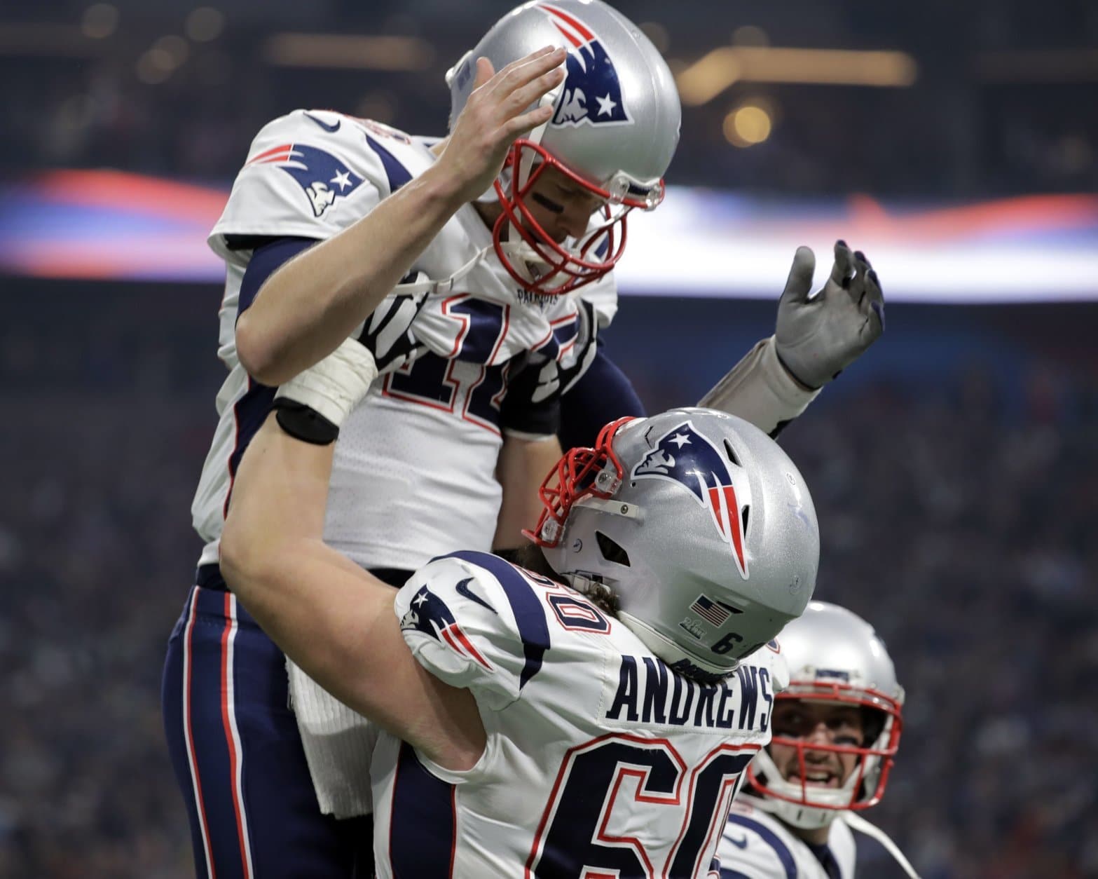 New England Patriots' David Andrews (60) picks up Tom Brady (12) after the Patriots scored a touchdown during the second half of the NFL Super Bowl 53 football game against the Los Angeles Rams Sunday, Feb. 3, 2019, in Atlanta. (AP Photo/Jeff Roberson)