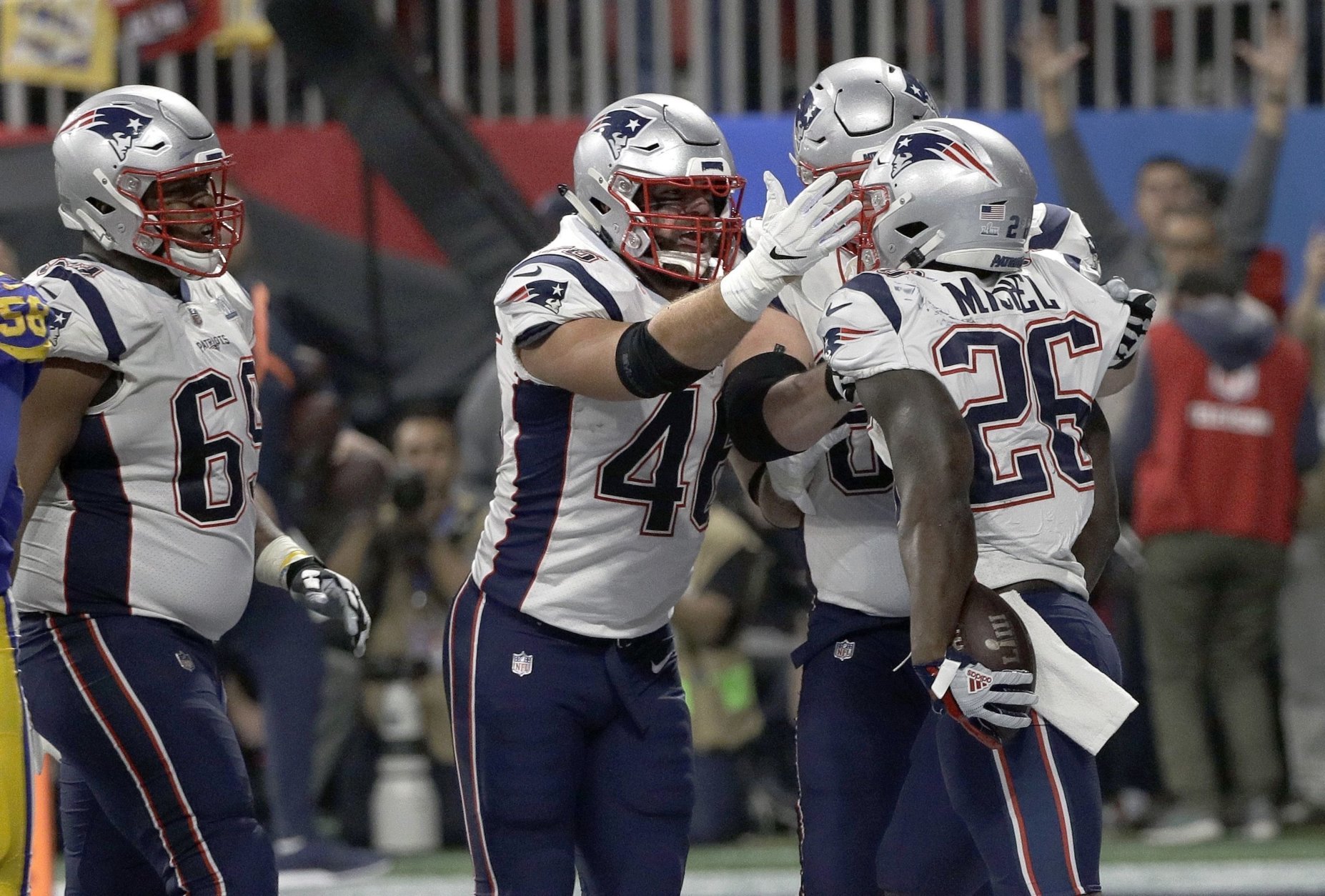 New England Patriots' Sony Michel (26) celebrates his touchdown with James Develin, center, during the second half of the NFL Super Bowl 53 football game against the Los Angeles Rams, Sunday, Feb. 3, 2019, in Atlanta. (AP Photo/David J. Phillip)