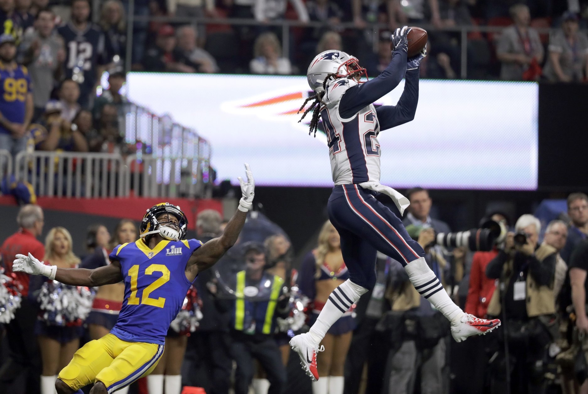 New England Patriots' Stephon Gilmore, right, intercepts a pass intended for Los Angeles Rams' Brandin Cooks (12) during the second half of the NFL Super Bowl 53 football game Sunday, Feb. 3, 2019, in Atlanta. (AP Photo/Chuck Burton)