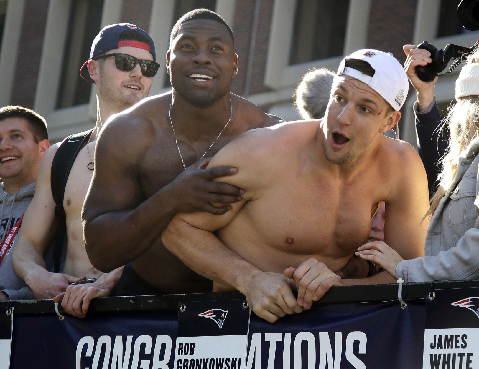 New England Patriots tight ends Dwayne Allen, left, and Rob Gronkowski react to fans during their victory parade through downtown Boston, Tuesday, Feb. 5, 2019, to celebrate their win over the Los Angeles Rams in Sunday's NFL Super Bowl 53 football game in Atlanta. The Patriots have won six Super Bowl championships. (AP Photo/Elise Amendola)