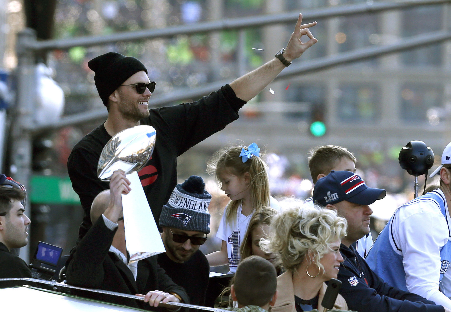 New England Patriots' Tom Brady rides beside the trophy as the team parades through downtown Boston, Tuesday, Feb. 5, 2019, to celebrate their win over the Los Angeles Rams in Sunday's NFL Super Bowl 53 football game in Atlanta. (AP Photo/Michael Dwyer)
