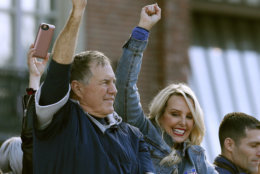 New England Patriots head coach Bill Belichick and partner Linda Holliday wave as the team parades through downtown Boston, Tuesday, Feb. 5, 2019, to celebrate their win over the Los Angeles Rams in Sunday's NFL Super Bowl 53 football game in Atlanta. (AP Photo/Michael Dwyer)