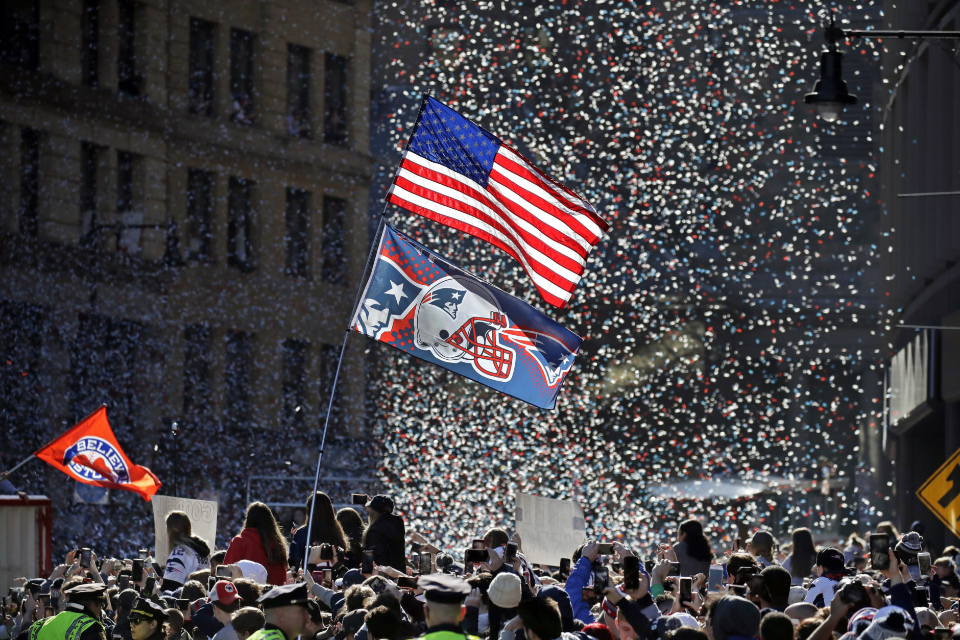 Confetti flies as fans watch the New England Patriots parade through downtown Boston, Tuesday, Feb. 5, 2019, to celebrate their win over the Los Angeles Rams in Sunday's NFL Super Bowl 53 football game in Atlanta. The Patriots have won six Super Bowl championships. (AP Photo/Elise Amendola)