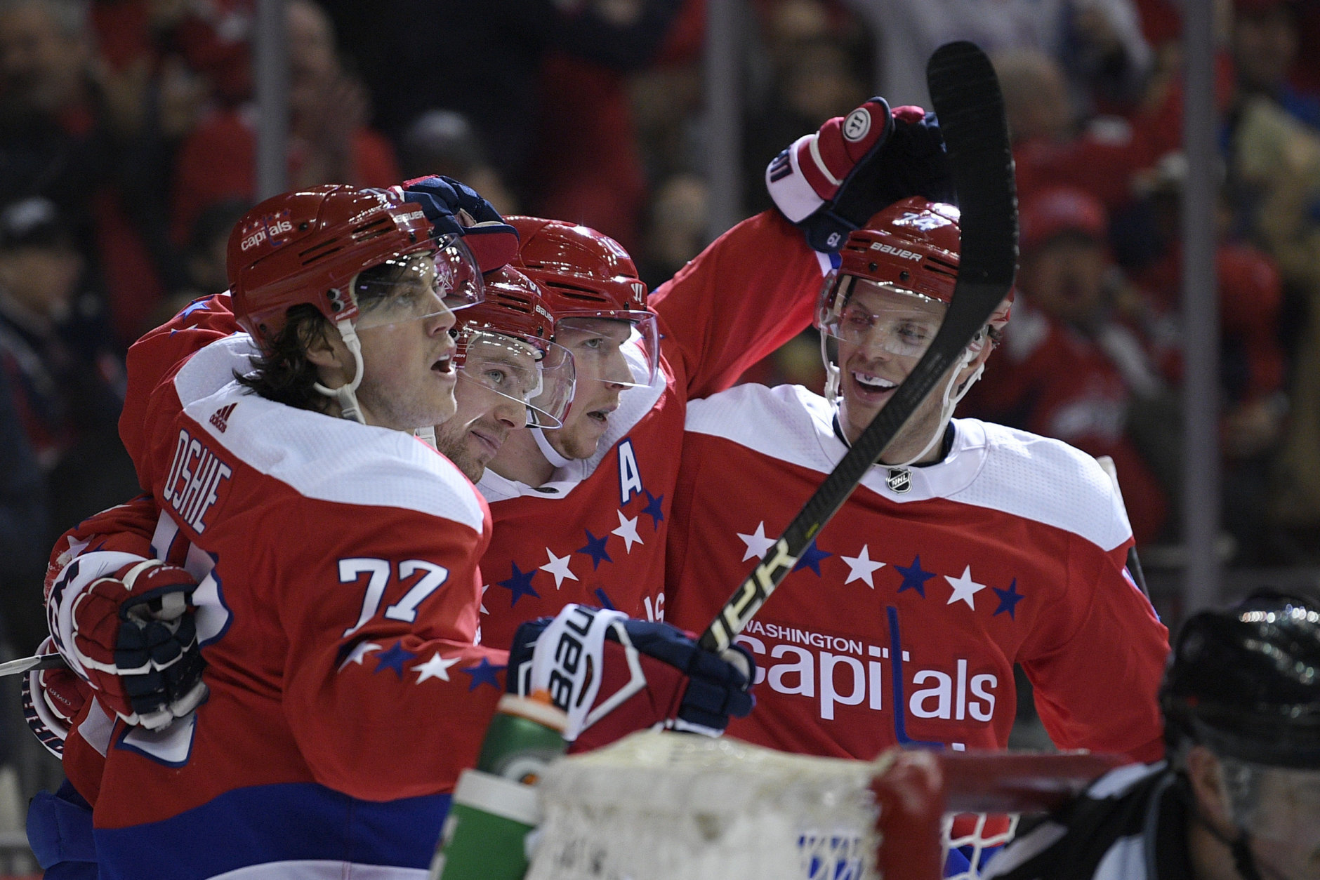 Washington Capitals center Evgeny Kuznetsov, second from the left, of Russia, celebrates his goal with right wing T.J. Oshie (77), center Nicklas Backstrom, third from right, and defenseman John Carlson, right, during the second period of an NHL hockey game against the Colorado Avalanche, Thursday, Feb. 7, 2019, in Washington. (AP Photo/Nick Wass)