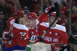 Washington Capitals center Evgeny Kuznetsov, second from the left, of Russia, celebrates his goal with right wing T.J. Oshie (77), center Nicklas Backstrom, third from right, and defenseman John Carlson, right, during the second period of an NHL hockey game against the Colorado Avalanche, Thursday, Feb. 7, 2019, in Washington. (AP Photo/Nick Wass)