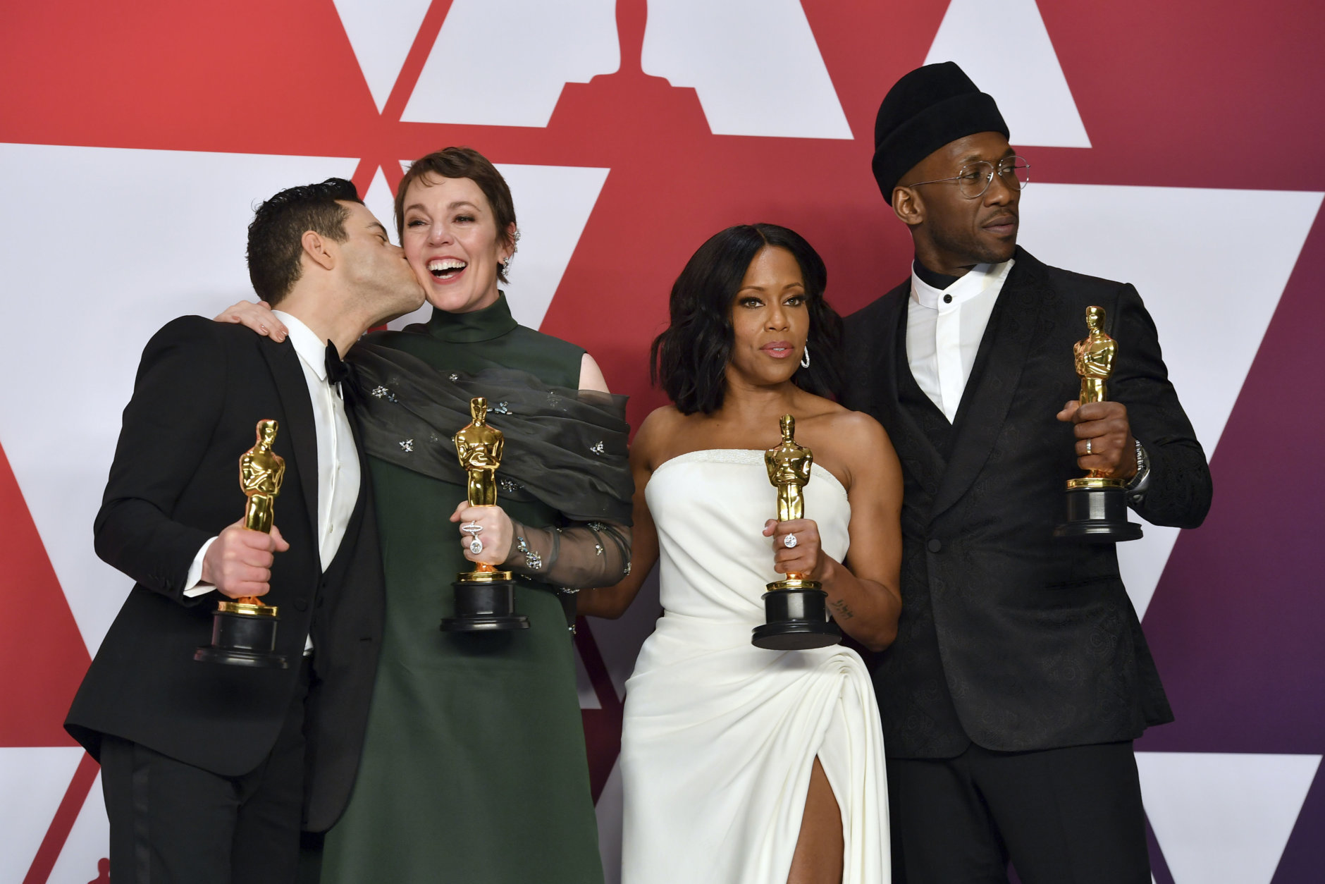 Rami Malek, left, winner of the award for best performance by an actor in a leading role for "Bohemian Rhapsody", kisses Olivia Colman, winner of the award for best performance by an actress in a leading role for "The Favourite", as they appear with Regina King, winner of the award for best performance by an actress in a supporting role for "If Beale Street Could Talk", and Mahershala Ali, winner of the award for best performance by an actor in a supporting role for "Green Book", right, in the press room at the Oscars on Sunday, Feb. 24, 2019, at the Dolby Theatre in Los Angeles. (Photo by Jordan Strauss/Invision/AP)
