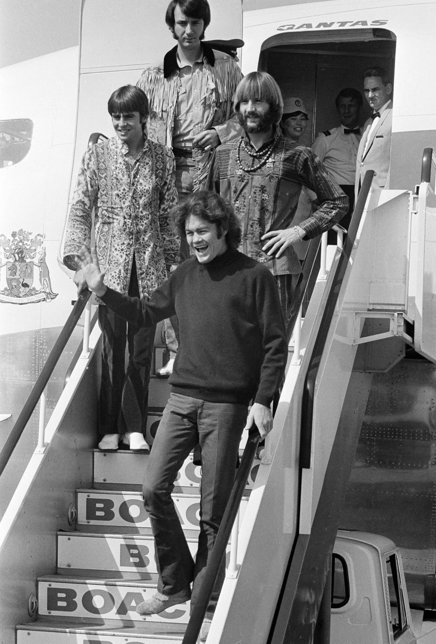 Pop musical group, "The Monkees," arrive at Tokyo International Airport September 30,1968 for performances in Tokyo, Kyoto, and Osaka.   About 1,000 fans, mostly Japanese teenage girls, gathered at the airport to see "The Monkees" arrive.  Members of the group arriving are from top: Mike Nesmith, David Jones, Peter Tork, hand on hip; and Mickey Dolenz.   (AP Photo/T. Sakakibara)