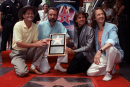 In this July 10, 1989 file photo, The Monkees, from left: Micky Dolenz, Mike Nesmith, Davy Jones and Peter Tork  get a star on the Hollywood Walk of Fame. (AP Photo/Mark Terrill)