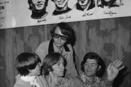 American pop band &quot;The Monkees&quot;, are seen beneath a poster with sketches of themselves, during their press conference in London, England, Thursday June 29, 1967. They are from left to right: Davy Jones, Peter Tork, Mike Nesmith and Micky Dolenz.. The band arrived yesterday and will give their first concert tomorrow at the Empire Pool, here in London. (AP Photo/Eddie Worth)