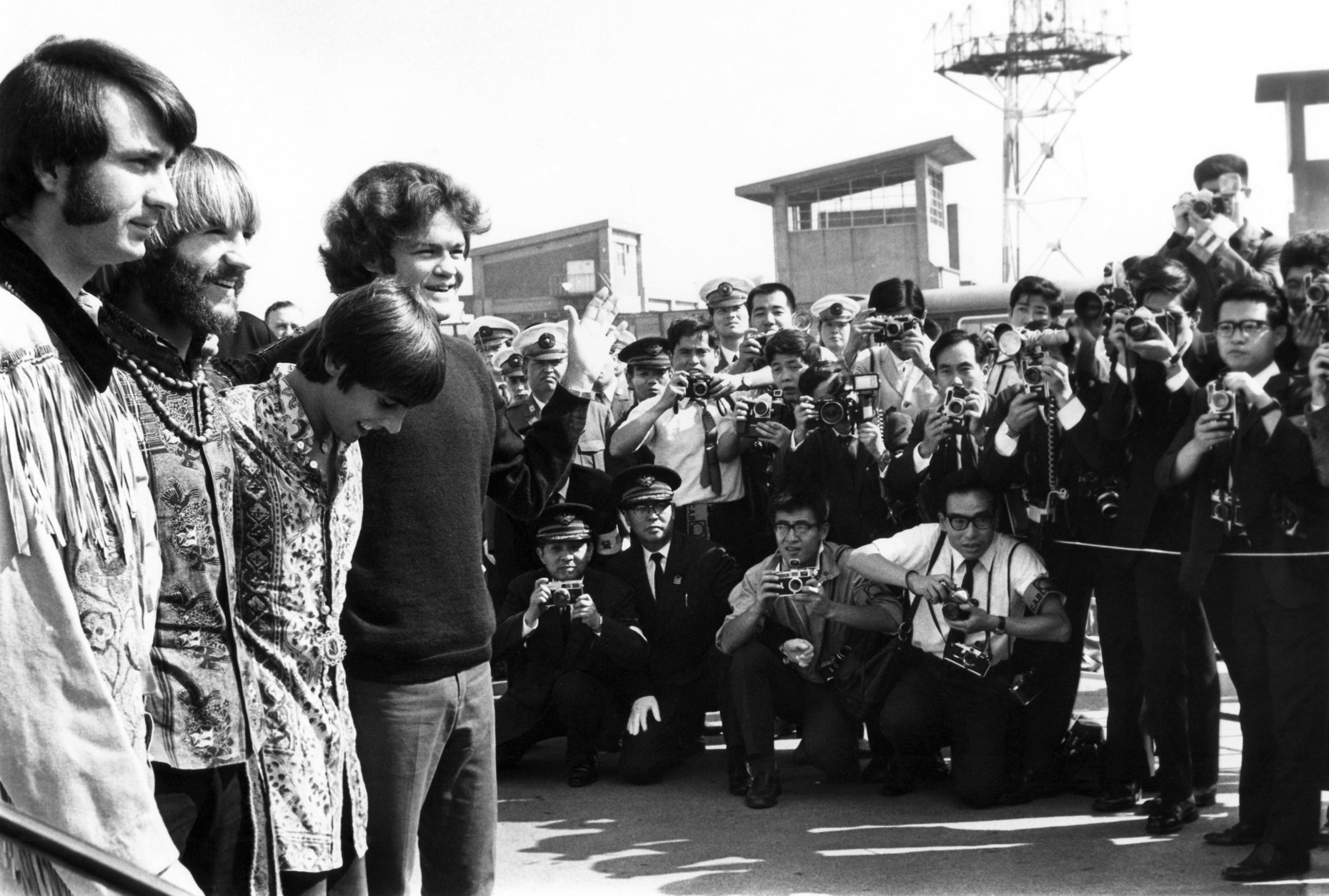 The pop musical group, The Monkees, arrived at Tokyo International Airport Sept. 30, 1968 for the performances in Tokyo, Kyoto and Osaka. About 1,000 Japanese fans, mostly teen aged girls gathered at the airport to see The Monkees. From right Micky Dolenz, Davy Jones, Peter Tork, Mike Nesmith. About 700 Japanese police surrounded the airport to protect Monkees from crowd but no mob scene. (AP Photo)