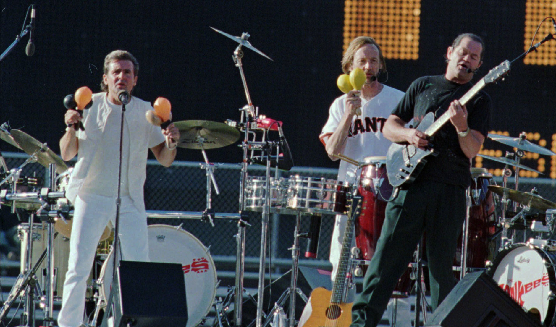 Davey Jones, left, Peter Tork, center, and Micky Dolenz, right,  three of the original members of the group known as "The Monkees" perform for the crowd before the Giants-Dodgers game at 3COM Park, Friday June 20, 1997, in San Francisco. (AP Photo/ Lacy Atkins)
