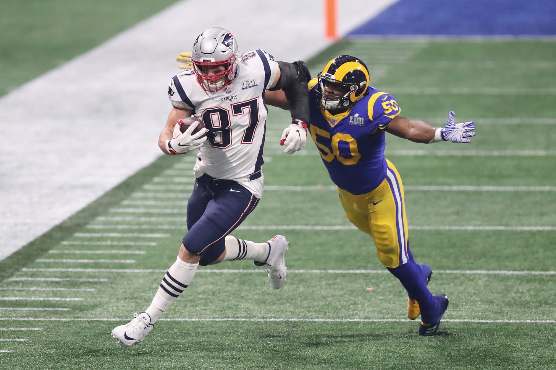 ATLANTA, GA - FEBRUARY 03:  Rob Gronkowski #87 of the New England Patriots makes a catch against Samson Ebukam #50 of the Los Angeles Rams in the second half during Super Bowl LIII at Mercedes-Benz Stadium on February 3, 2019 in Atlanta, Georgia.  (Photo by Elsa/Getty Images)
