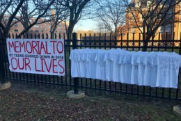 Students at Bethesda-Chevy Chase High School observed the Thursday anniversary of the high school shooting at Parkland, Florida by hanging up 671 white T-shirts along a fence on East-West Highway. (WTOP/Nick Iannelli)