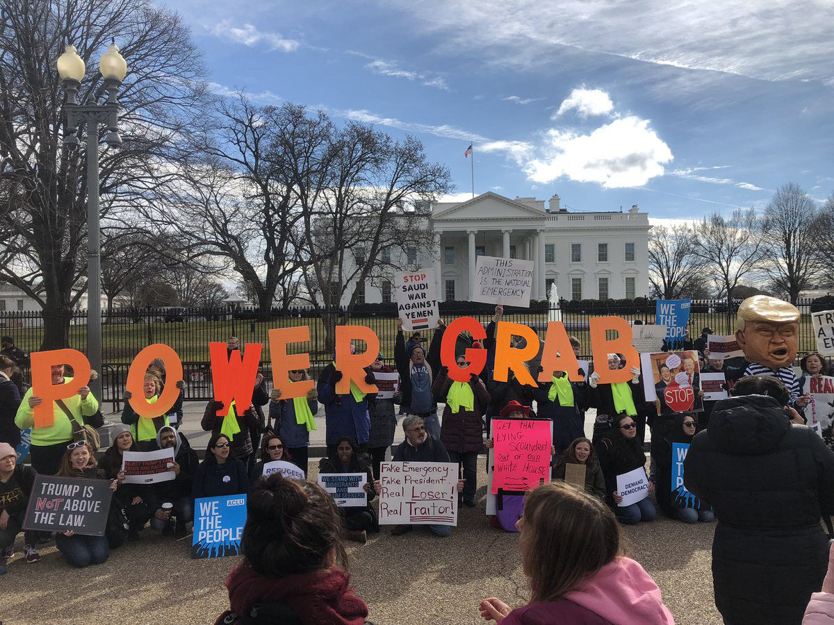 Demonstrators protest President Trump's natoinal emergency declaration across the street frmo the White House Feb. 18, 2019. (WTOP/Mike Murillo)