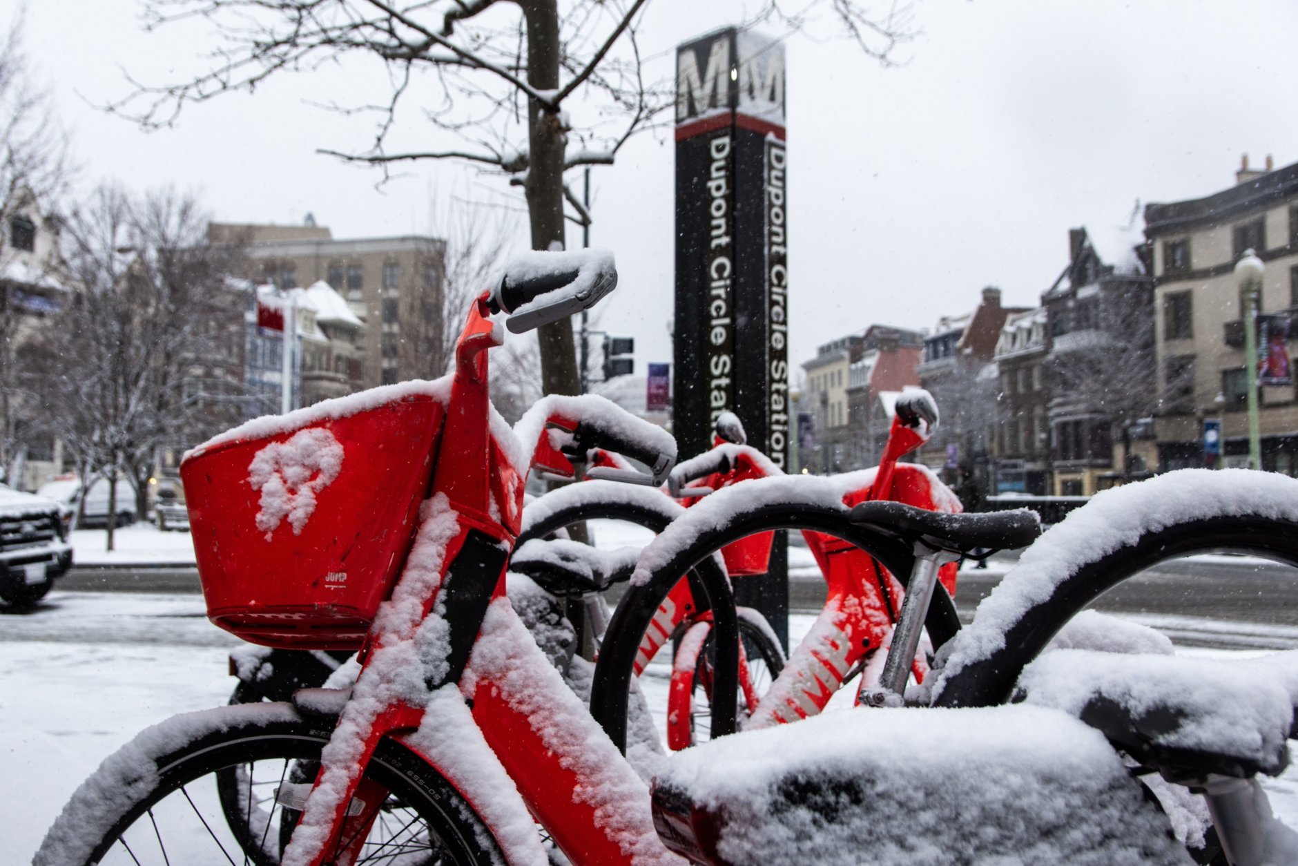 A Jump bikeshare outside the Dupont Circle Metro Station. Despite the snow, some people were seen using bikes on the sidewalk. (WTOP/Alejandro Alvarez)