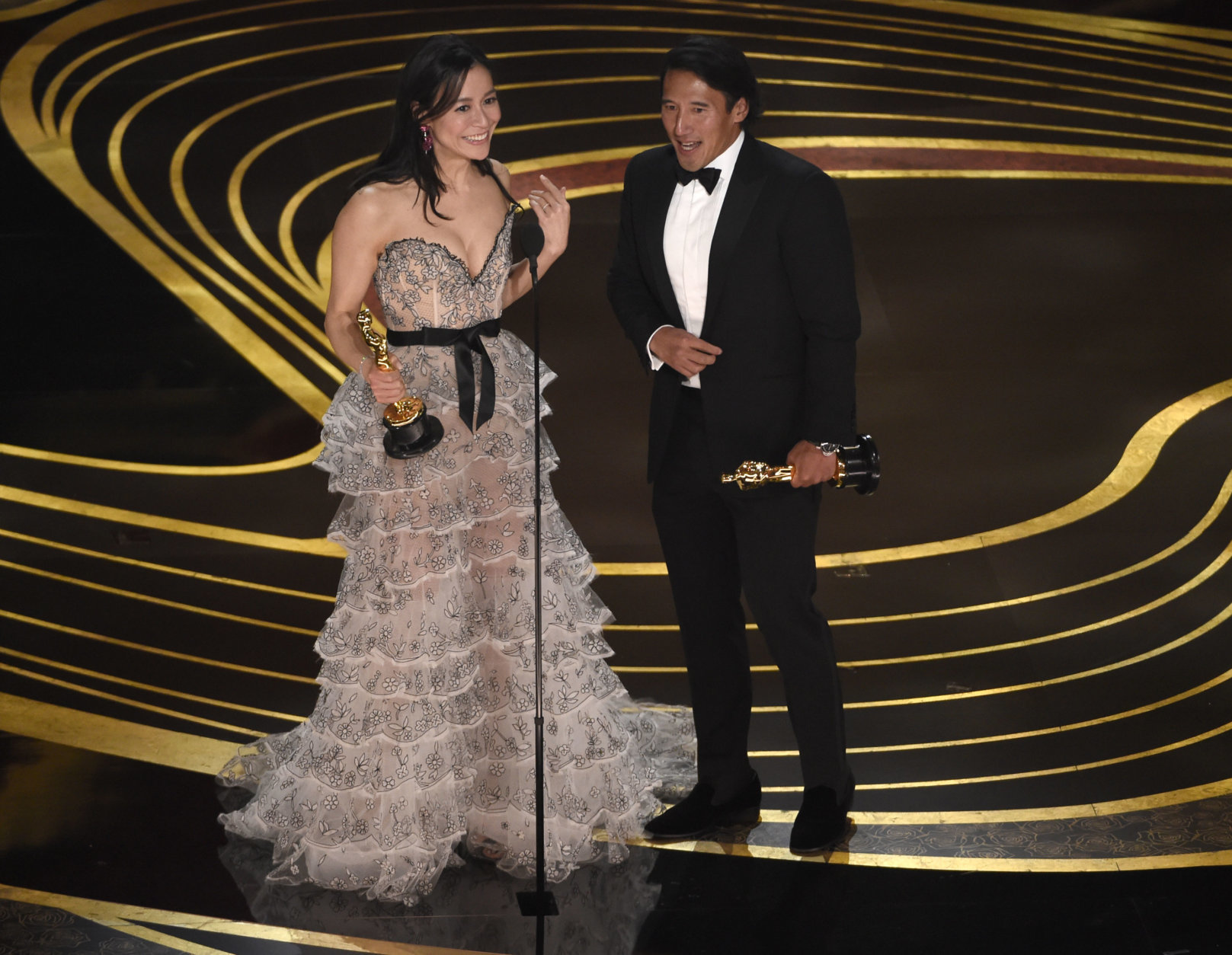 Elizabeth Chai Vasarhelyi, left, and Jimmy Chin accept the award for best documentary feature for "Free Solo" at the Oscars on Sunday, Feb. 24, 2019, at the Dolby Theatre in Los Angeles. (Photo by Chris Pizzello/Invision/AP)