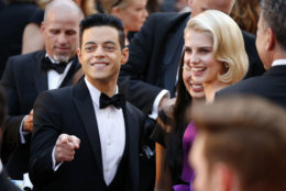 Rami Malek, left, and Lucy Boynton arrive at the Oscars on Sunday, Feb. 24, 2019, at the Dolby Theatre in Los Angeles. (Photo by Eric Jamison/Invision/AP)