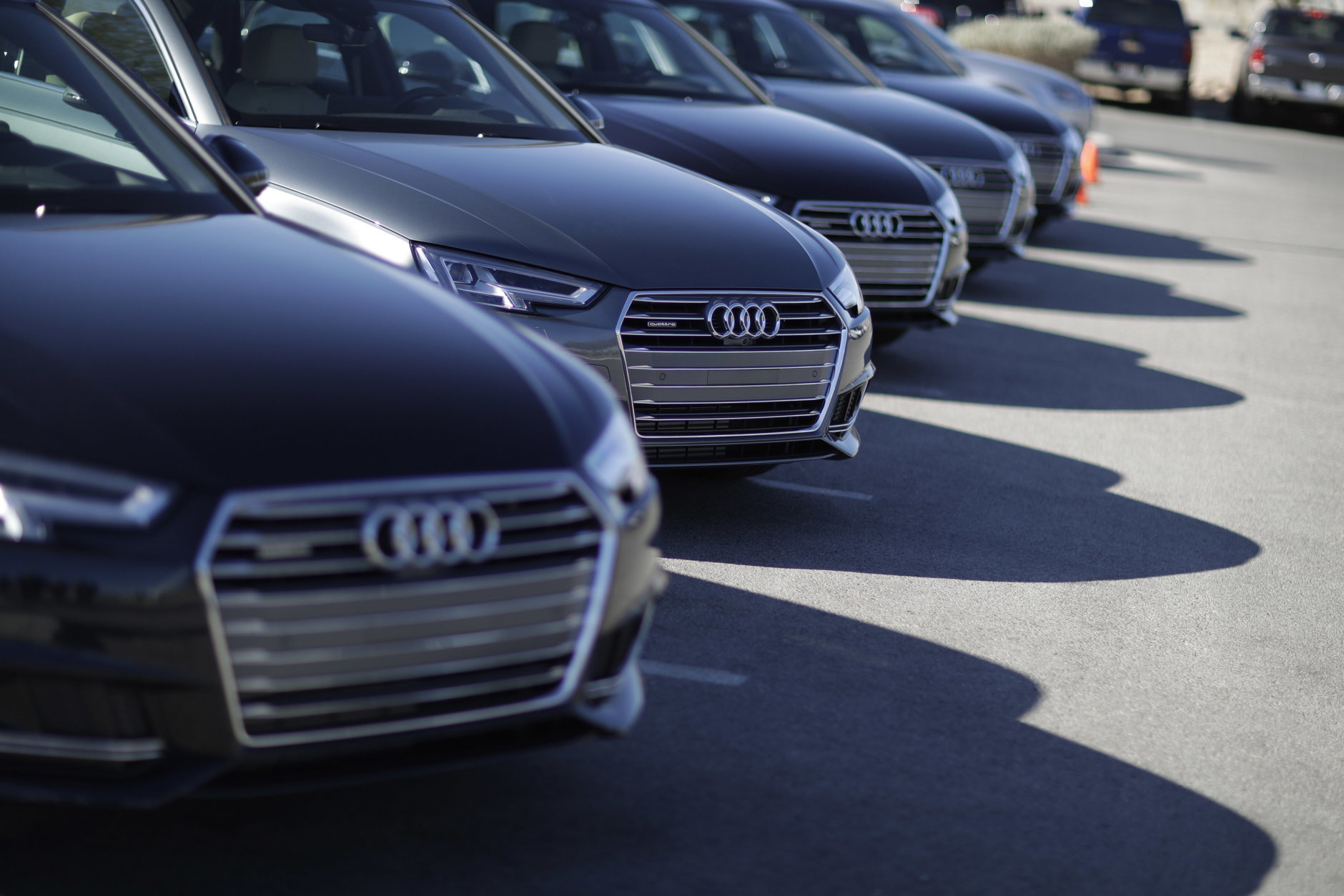 A line of Audi A4 cars are parked before a demonstration of Audi's vehicle-to-infrastructure technology Tuesday, Dec. 6, 2016, in Las Vegas. The technology allows vehicles to "read" red lights ahead and tell the driver how long it'll be before the signal turns green. For the driver, the system puts a traffic signal icon on the dashboard telling how many seconds the light will remain red. (AP Photo/John Locher)