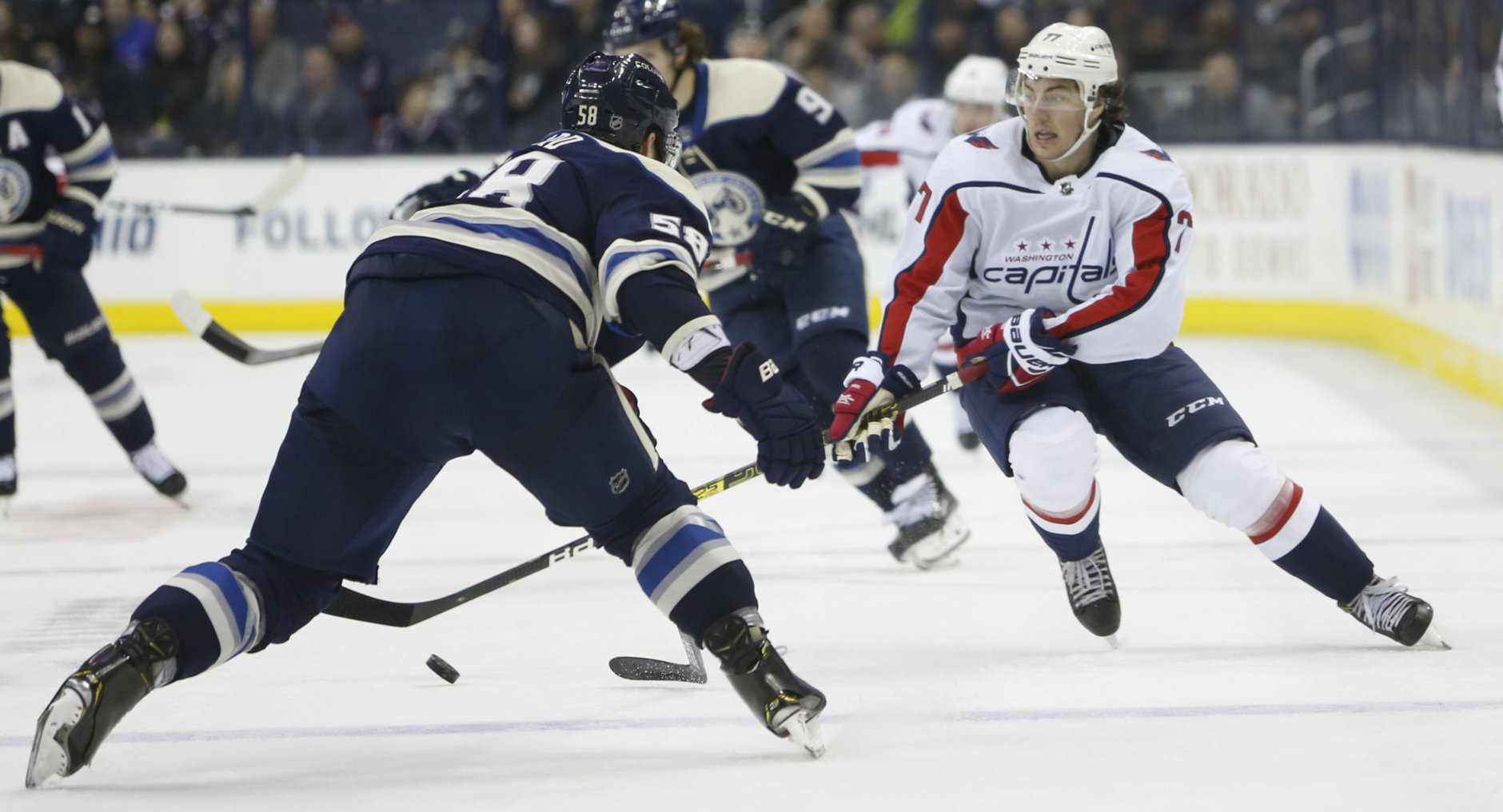 Washington Capitals' T.J. Oshie, right, carries the puck across the blue line as Columbus Blue Jackets' David Savard defends during the third period of an NHL hockey game Tuesday, Feb. 12, 2019, in Columbus, Ohio. The Blue Jackets beat the Capitals 3-0. (AP Photo/Jay LaPrete)