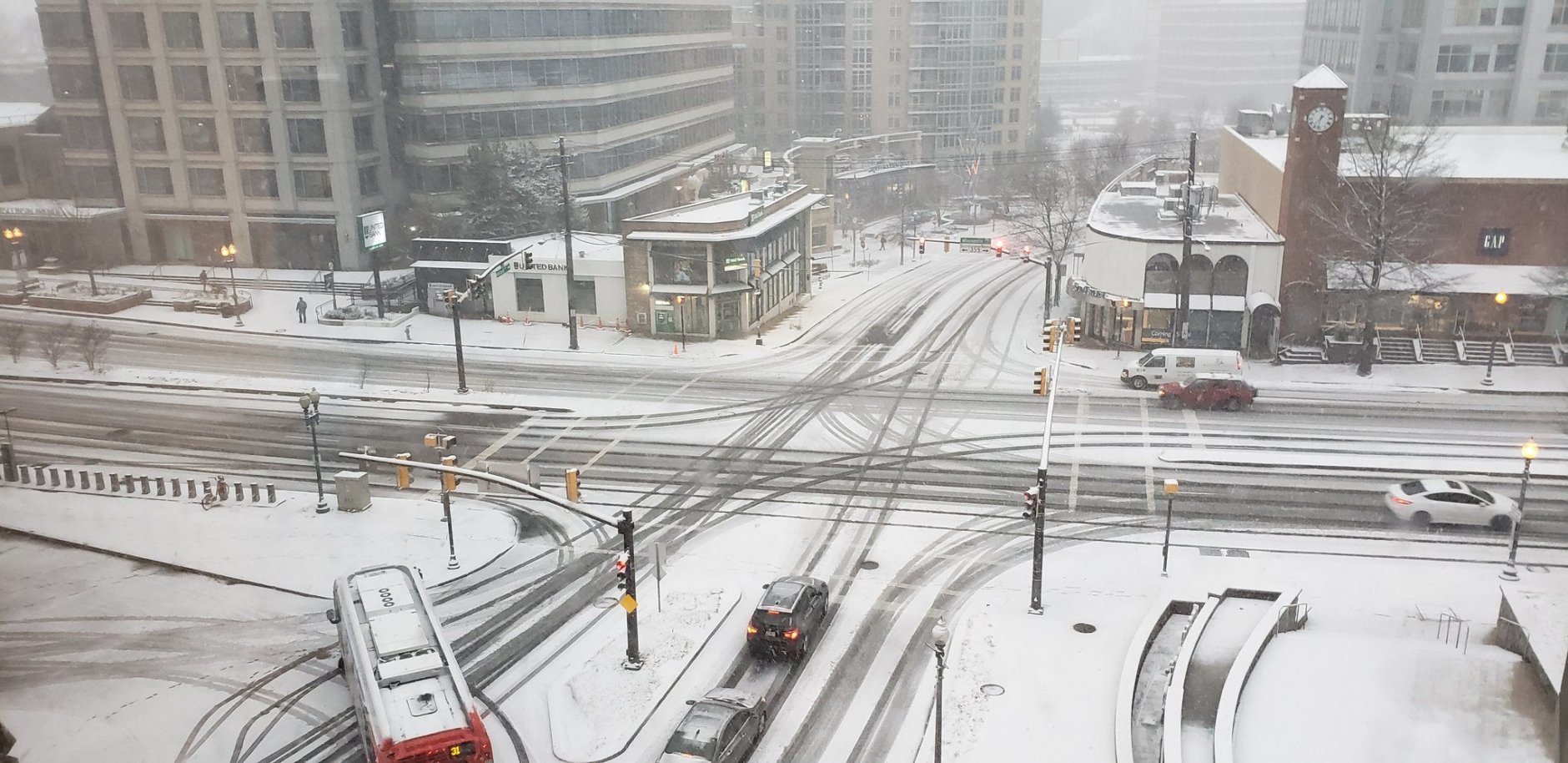 Tire tracks cut through the snow at this Friendship Heights intersection. (WTOP/Brandon Millman)