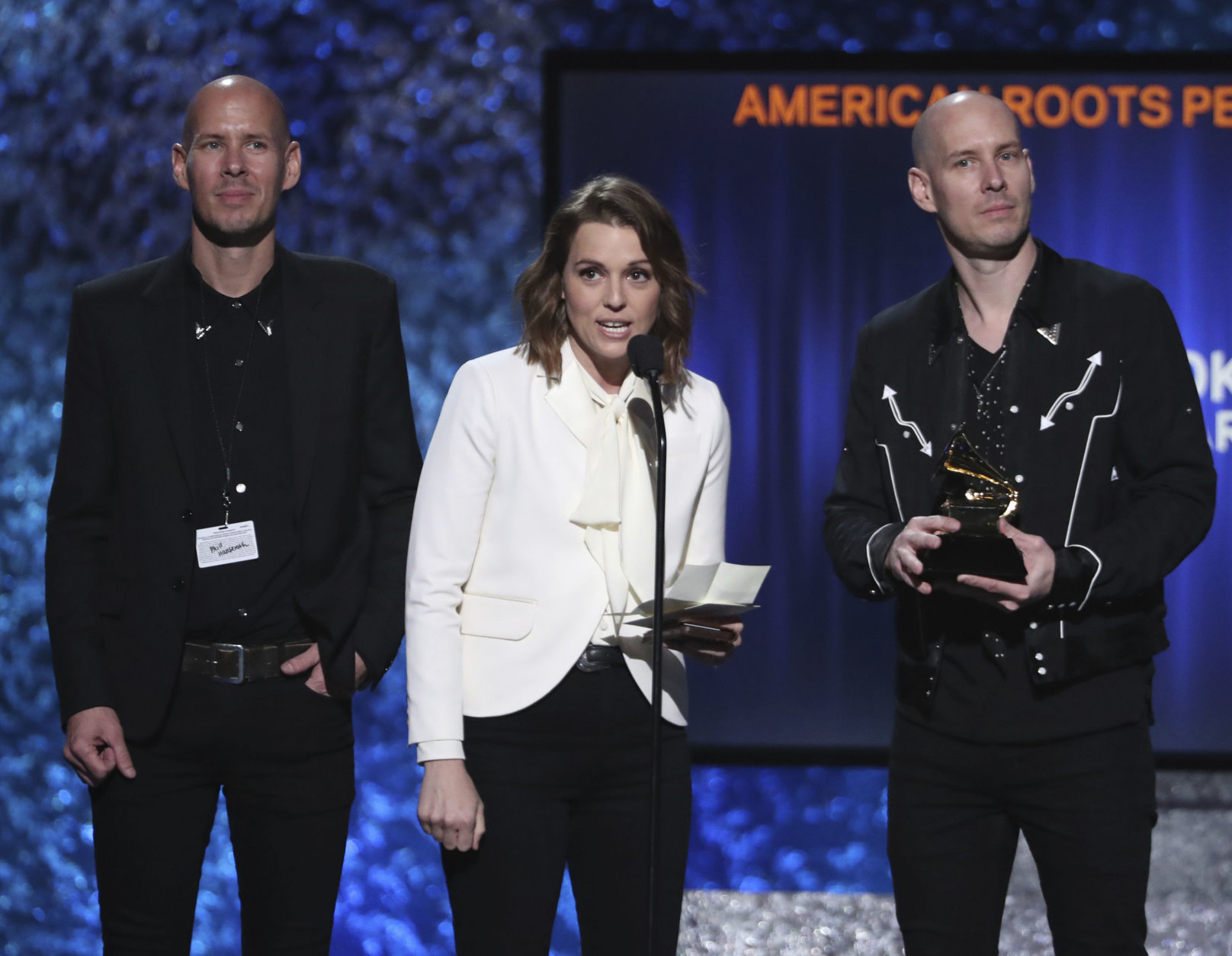 Phil Hanseroth, from left, Brandi Carlile and Tim Hanseroth accept the award for best American roots performance for "The Joke" at the 61st annual Grammy Awards on Sunday, Feb. 10, 2019, in Los Angeles. (Photo by Matt Sayles/Invision/AP)