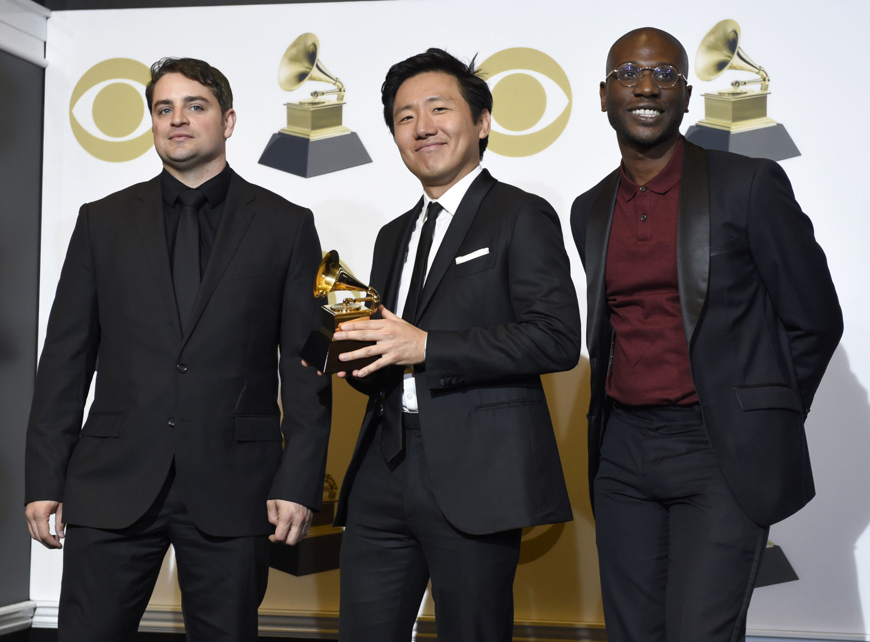 Jason Cole, from left, Hiro Murai and Ibra Ake pose in the press room with the award for best music video for Childish Gambino's "This Is America" at the 61st annual Grammy Awards at the Staples Center on Sunday, Feb. 10, 2019, in Los Angeles. (Photo by Chris Pizzello/Invision/AP)