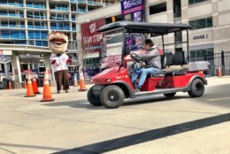 Would-be bullpen cart drivers audition in center field plaza at Nationals Park. (WTOP/Neal Augenstein)