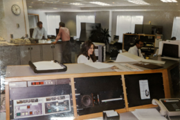Former news and programming director Michelle Komes-Dolge (center) and Mike McMearty (right), who currently holds the title, work at the editor's desk back before renovations at 3400. (Courtesy Mike McMearty)