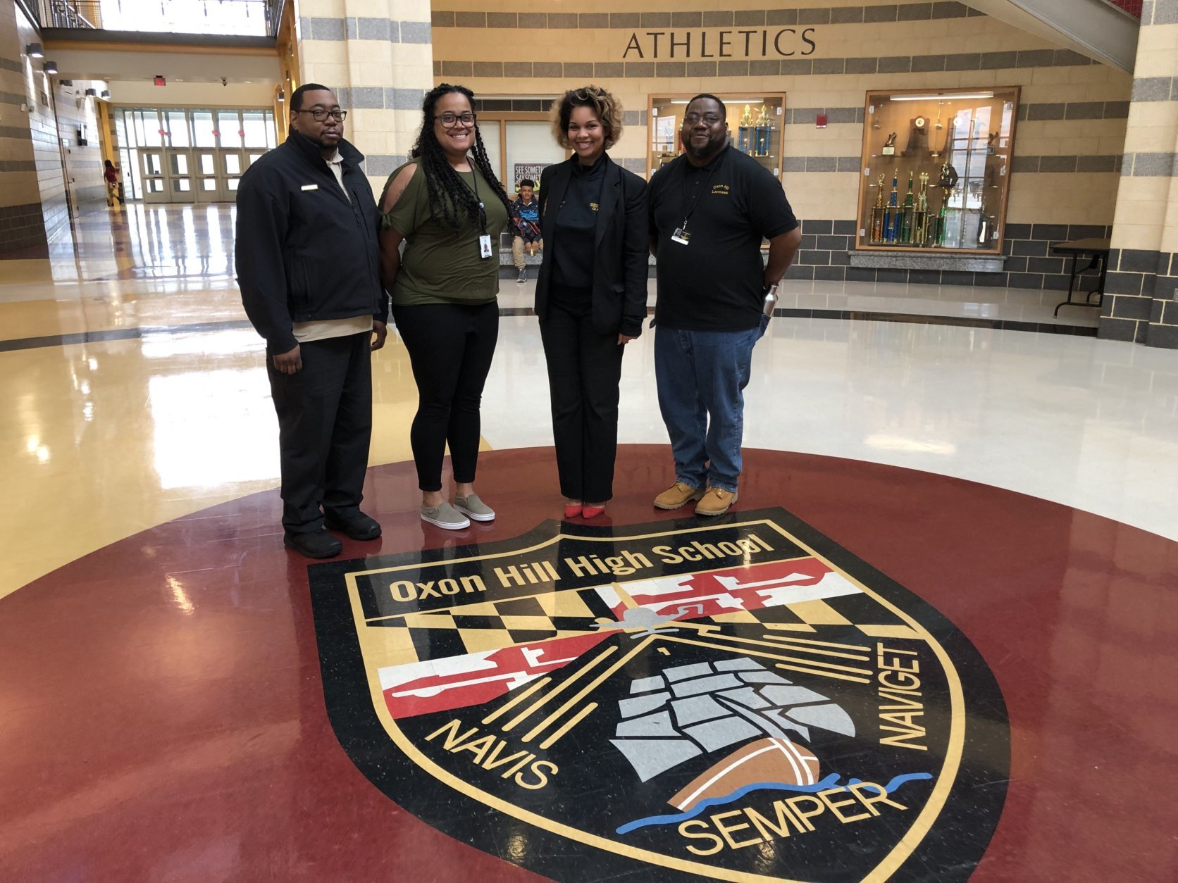Pictured with staff, Oxon Hill High School Principal Mar-c Holland, second from right, said driver safety will continue to be part of the curriculum.  (WTOP/Kristi King) 