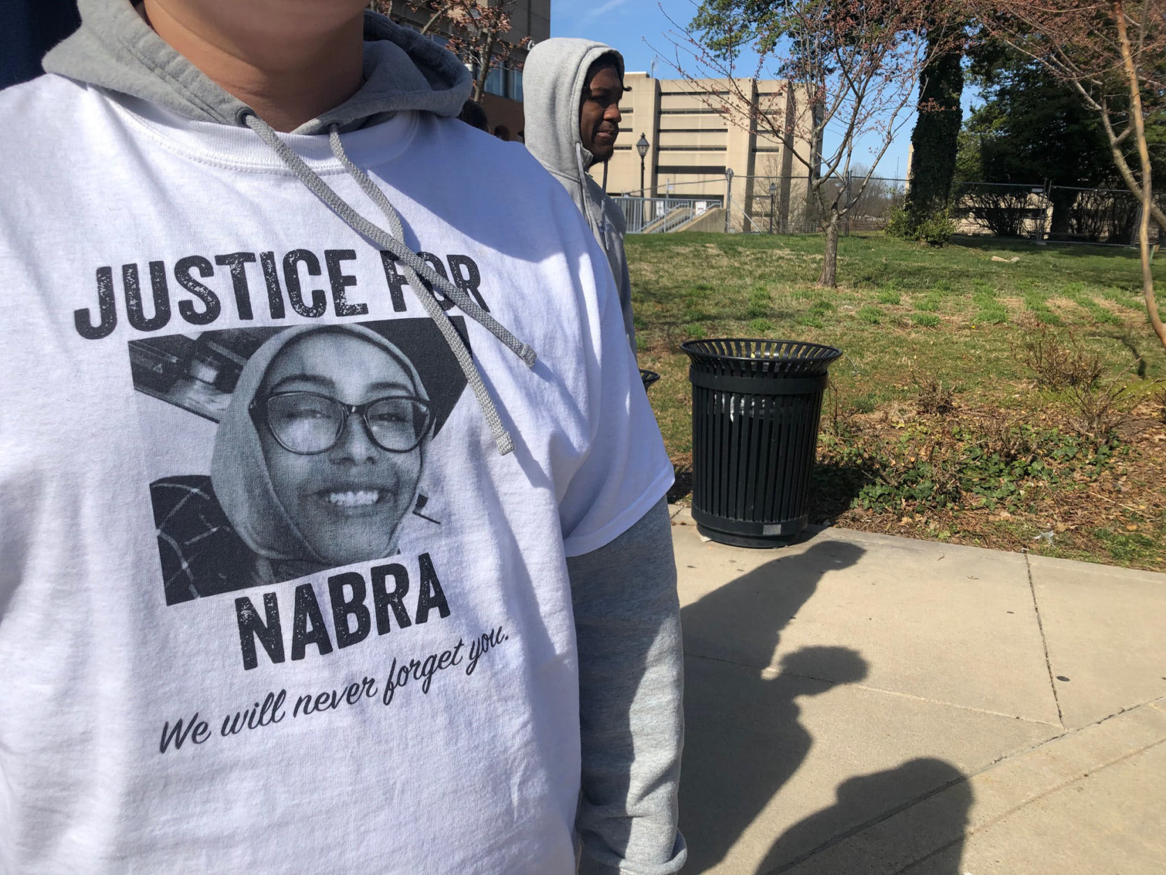 A person with a "Justice for Nabra" T-shirt ouside the Fairfax County Courthouse. (WTOP/Megan Cloherty)