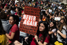 A student holds up a poster with the words "never again," a common rallying cry in the aftermath of the Parkland shooting which gained traction in the run-up to the March for Our Lives. (WTOP/Alejandro Alvarez)