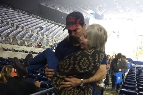 Picture of firefighter carrying elderly woman up some stairs is capturing hearts