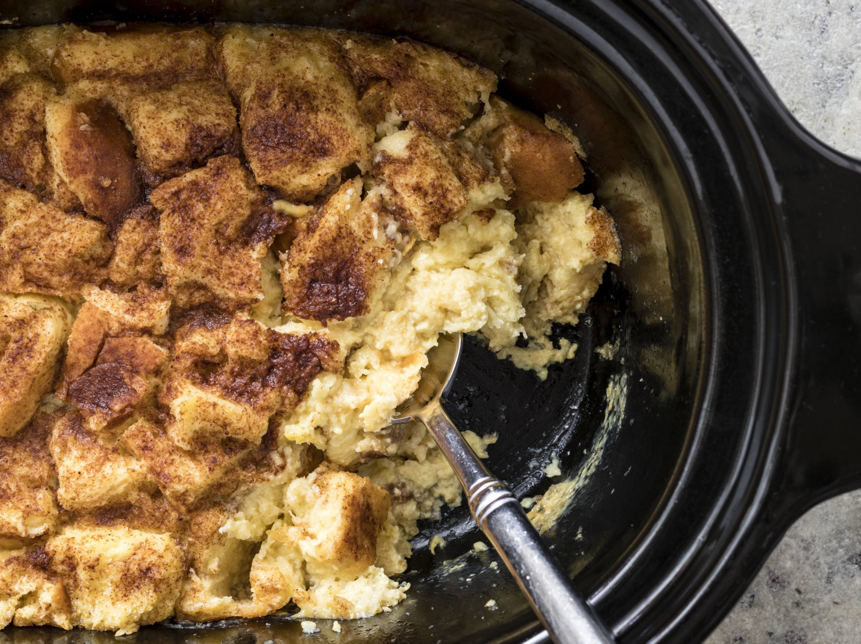 This undated photo provided by America's Test Kitchen shows Classic Bread Pudding in Brookline, Mass. This recipe appears in “The Complete Slow Cooker.” (Daniel J. van Ackere/America's Test Kitchen via AP)