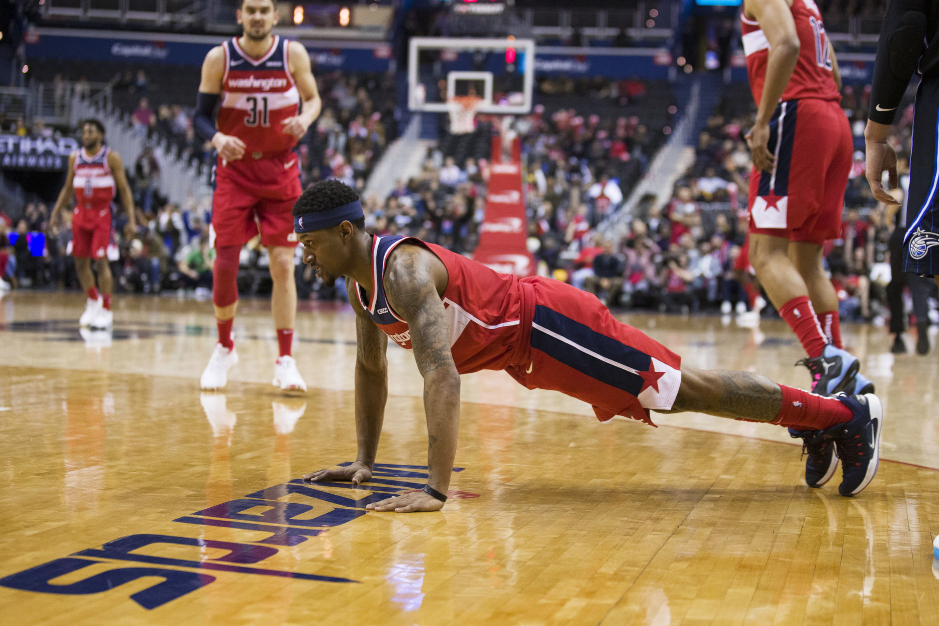 Washington Wizards guard Bradley Beal does a push-up after a play during the second half of the team's NBA basketball game against the Orlando Magic, Wednesday, March 13, 2019, in Washington. The Wizards won 100-90. (AP Photo/Alex Brandon)