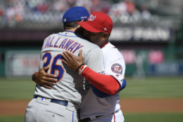 New York Mets manager Mickey Callaway (36) greets Washington Nationals manager Dave Martinez (4) before an opening day baseball game, Thursday, March 28, 2019, in Washington. (AP Photo/Nick Wass)