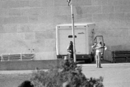 Associated Press reporter Steve Komarow, right, shows anti-nuclear weapons activist Norman Mayer, left, that he is  unarmed, at the base of the Washington Monument in Washington, D.C., Dec. 8, 1982. Mayer drove a white truck up to the monument and threatened to blow it up with 1,000 pounds of dynamite. Komarow was picked from a pool of reporters after Mayer requested to speak to a member of the news media. (AP Photo/Scott Stewart)