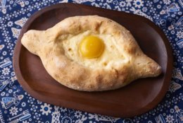 Khachapuri, a cheese-filled bread, topped with an egg, is one of the most popular dishes on the menu at Supra. (Courtesy Supra/Andrew Propp)