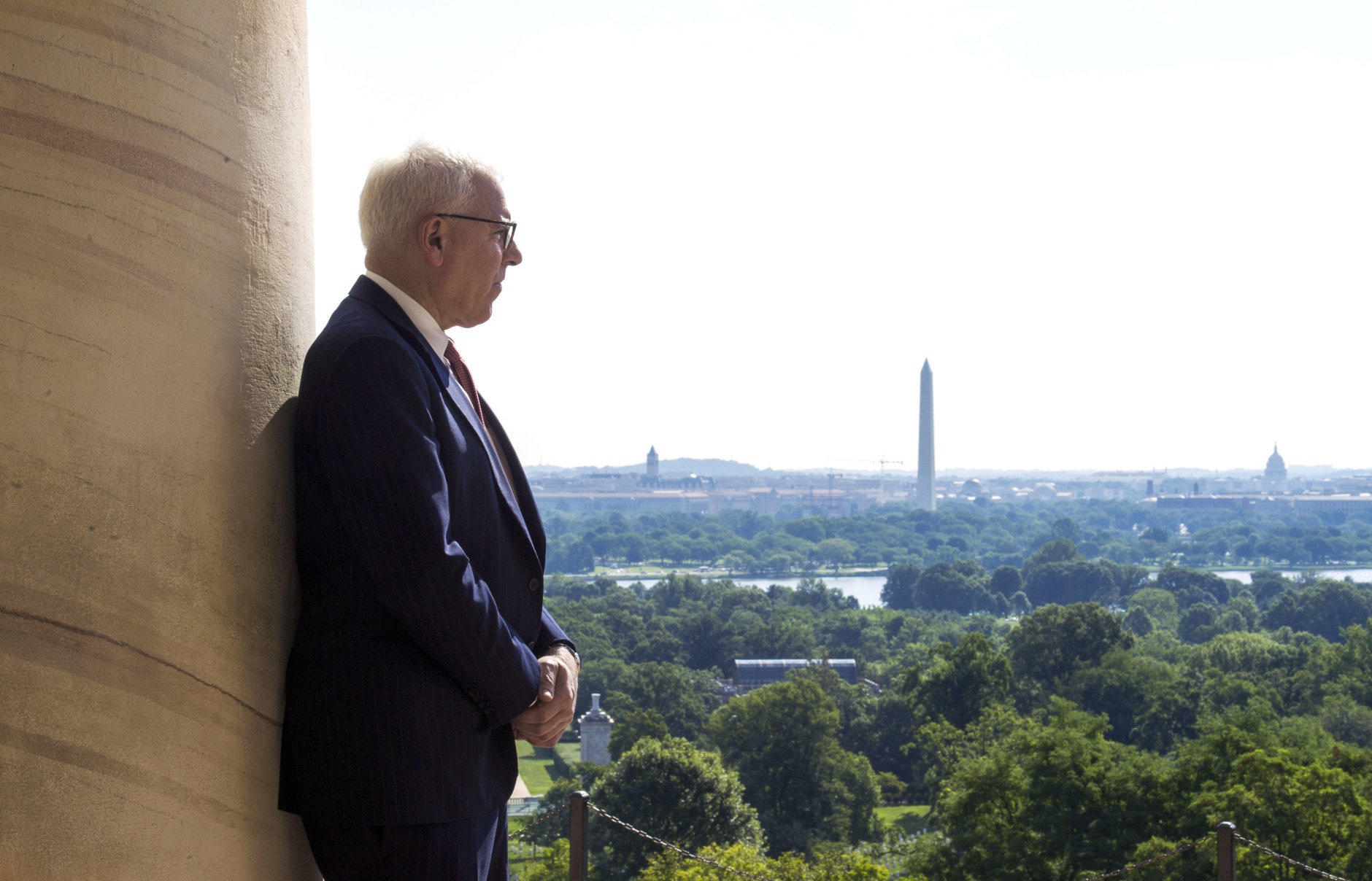 Philanthropist David Rubenstein stands by a portico pillar of the historical Arlington House at Arlington National Cemetery in Arlington, Va., Thursday, July 17, 2014. The historic house and plantation originally built as a monument to George Washington overlooking the nations capital that later was home to Confederate Gen. Robert E. Lee and 63 slaves will be restored to its historical appearance after a $12.3 million gift from Rubenstein. (AP Photo/Cliff Owen))