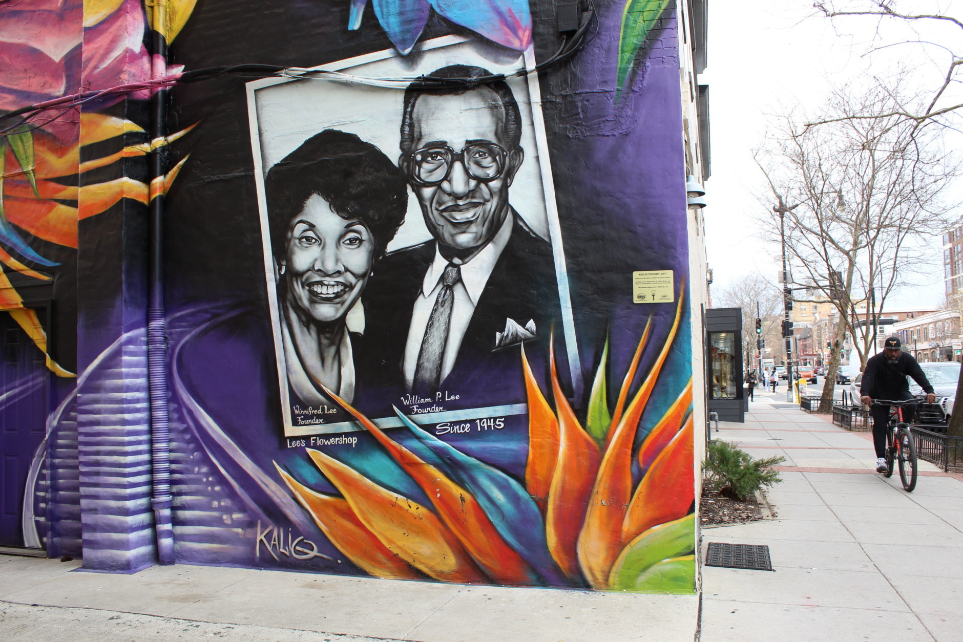 A mural depicting William and Winnifred Lee rests on the east side of the building. The couple opened Lee's Flower and Card in 1945. The shop remains one of the most well-known black-owned businesses in the city. (WTOP/Hallie Mellendorf)