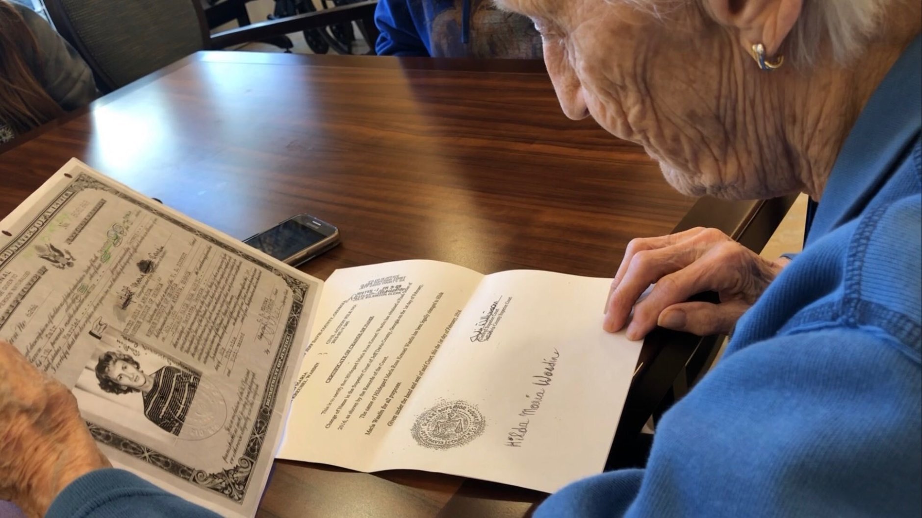 Poet's Walk resident Hilda Wasdin, 86, reviews documents from her past. (WTOP/Kristi King)