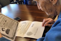Poet's Walk resident Hilda Wasdin, 86, reviews documents from her past. (WTOP/Kristi King)