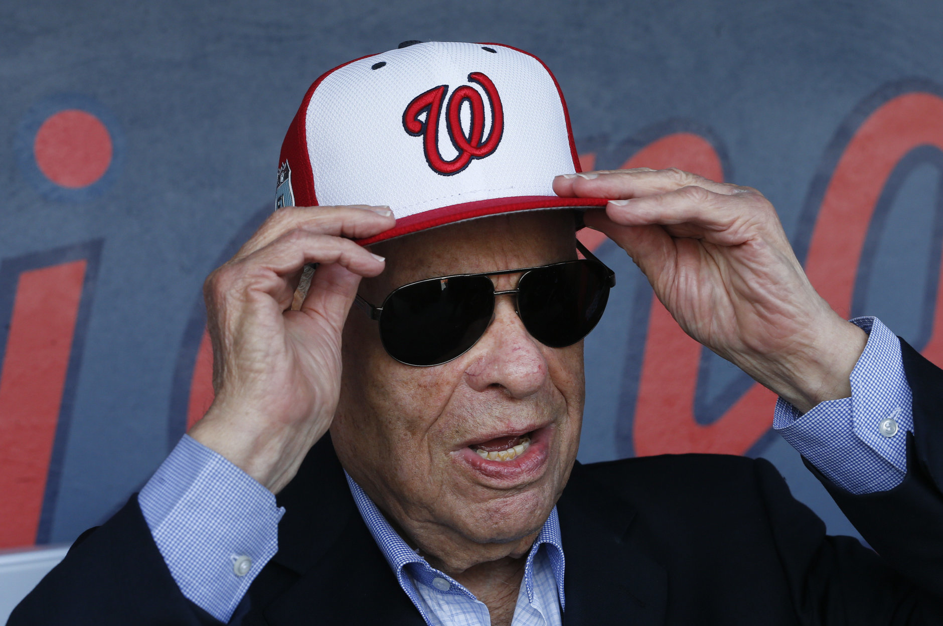 Washington Nationals owner Ted Lerner tries on a baseball cap before a ribbon cutting ceremony to open The Ballpark of the Palm beaches before of a spring training baseball game against the Houston Astros Tuesday, Feb. 28, 2017 in West Palm Beach, Fla. The stadium will serve as spring home for both Washington Nationals and Houston Astros. (AP Photo/John Bazemore)