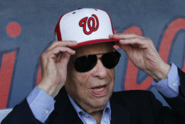 Washington Nationals owner Ted Lerner tries on a baseball cap before a ribbon cutting ceremony to open The Ballpark of the Palm beaches before of a spring training baseball game against the Houston Astros Tuesday, Feb. 28, 2017 in West Palm Beach, Fla. The stadium will serve as spring home for both Washington Nationals and Houston Astros. (AP Photo/John Bazemore)