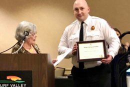 Barbara May, Historic Preservation Awards Chairman for the Daughters of the American Revolution, presents Captain Ushinski with the Historic Preservation Award. (Courtesy Prince George's County Fire and EMS)