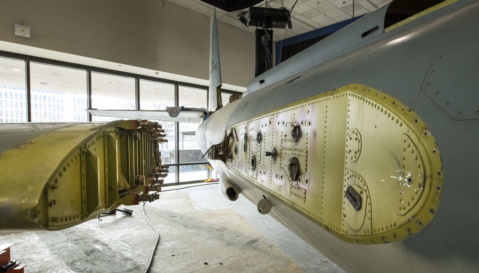 The right wing is unbolted and separated from the fuselage of the Lockheed U-2 aircraft after it was lowered from the ceiling in the closed Looking at Earth gallery in the National Air and Space Museum in Washington, DC, February 19 2019. (Smithsonian photo by Jim Preston)  Material is subject to Smithsonian Terms of Use. Should you wish to use National Air and Space material in any medium, please submit an Application for Permission to Reproduce NASM Material, available at:  https://airandspace.si.edu/permissions