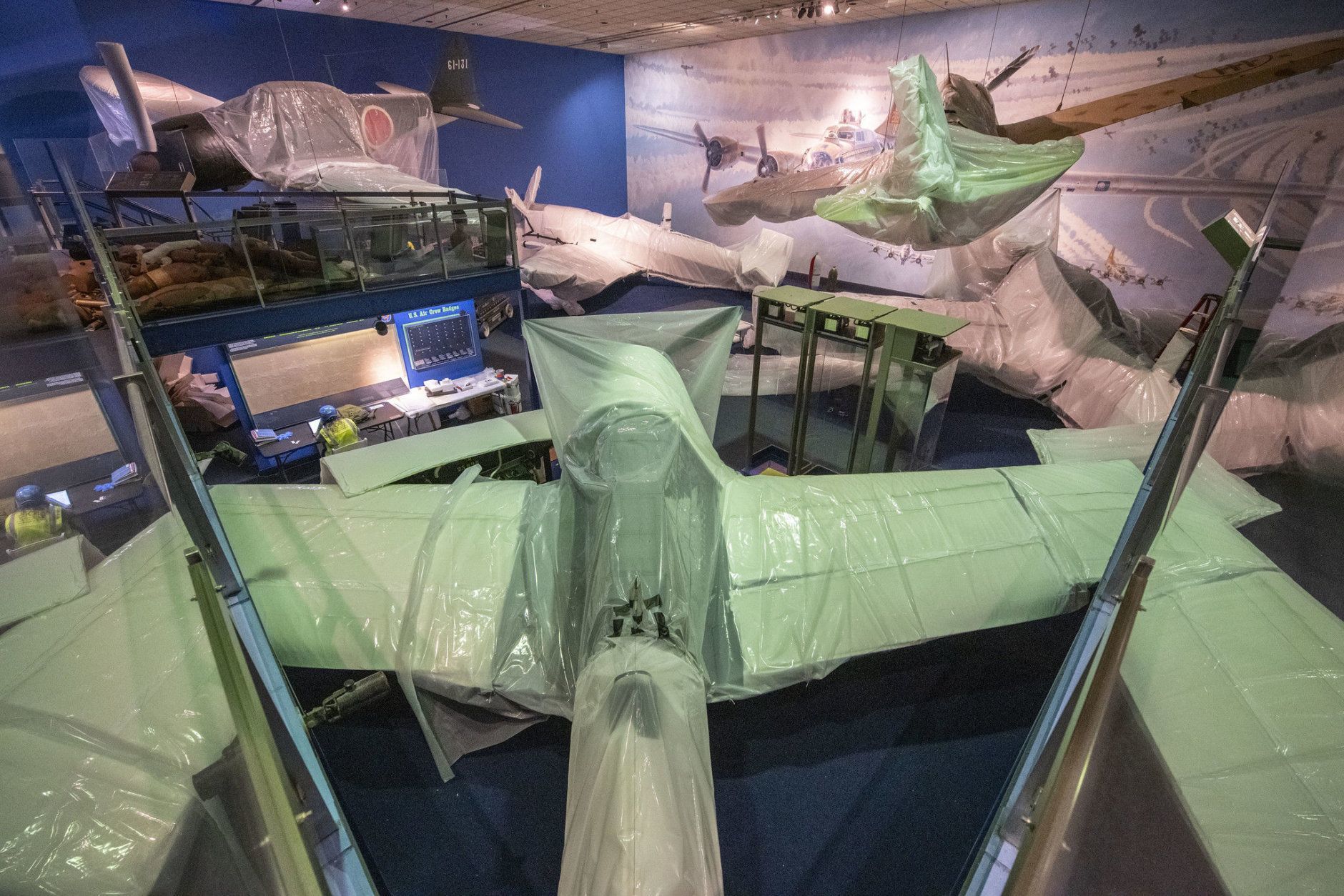 Aircraft are wrapped for protection prior to stage one demolition in the closed World War II Gallery in the National Air and Space Museum in Washington, DC, March 5, 2019. (Smithsonian photo by Jim Preston)  Material is subject to Smithsonian Terms of Use. Should you wish to use National Air and Space material in any medium, please submit an Application for Permission to Reproduce NASM Material, available at:  https://airandspace.si.edu/permissions