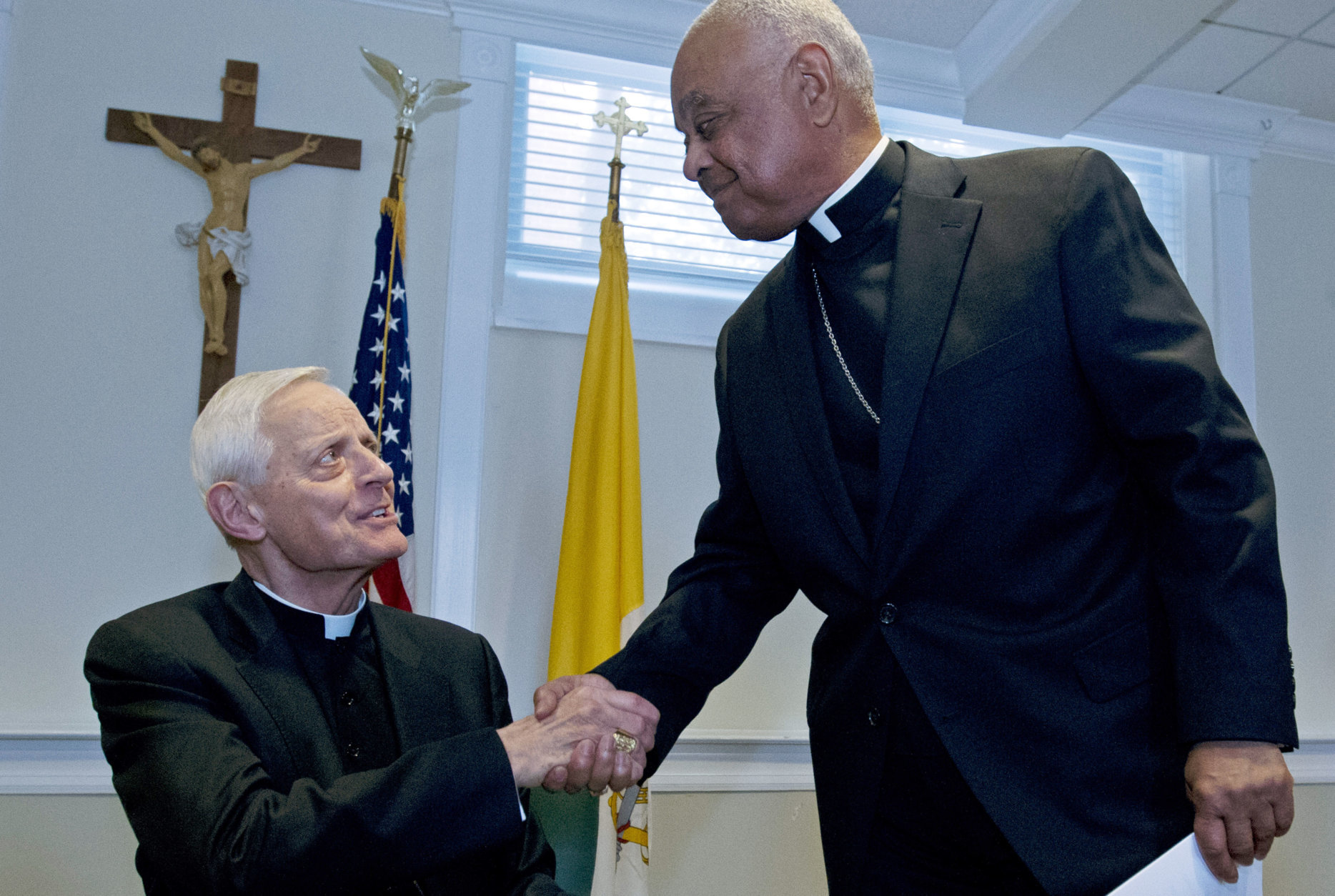 Archbishop designated by Pope Francis to the Archdiocese of Washington, Archbishop Wilton D. Gregory, right, shake hands with Cardinal Donald Wuerl, during the news conference at Washington Archdiocesan Pastoral Center in Hyattsville, Md., Thursday, April 4, 2019. Archbishop-designate Gregory will succeed Cardinal Donald Wuerl. (AP Photo/Jose Luis Magana)
