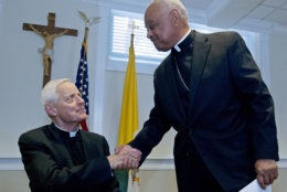 Archbishop designated by Pope Francis to the Archdiocese of Washington, Archbishop Wilton D. Gregory, right, shake hands with Cardinal Donald Wuerl, during the news conference at Washington Archdiocesan Pastoral Center in Hyattsville, Md., Thursday, April 4, 2019. Archbishop-designate Gregory will succeed Cardinal Donald Wuerl. (AP Photo/Jose Luis Magana)